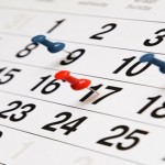 Closeup calendar page with drawing-pins